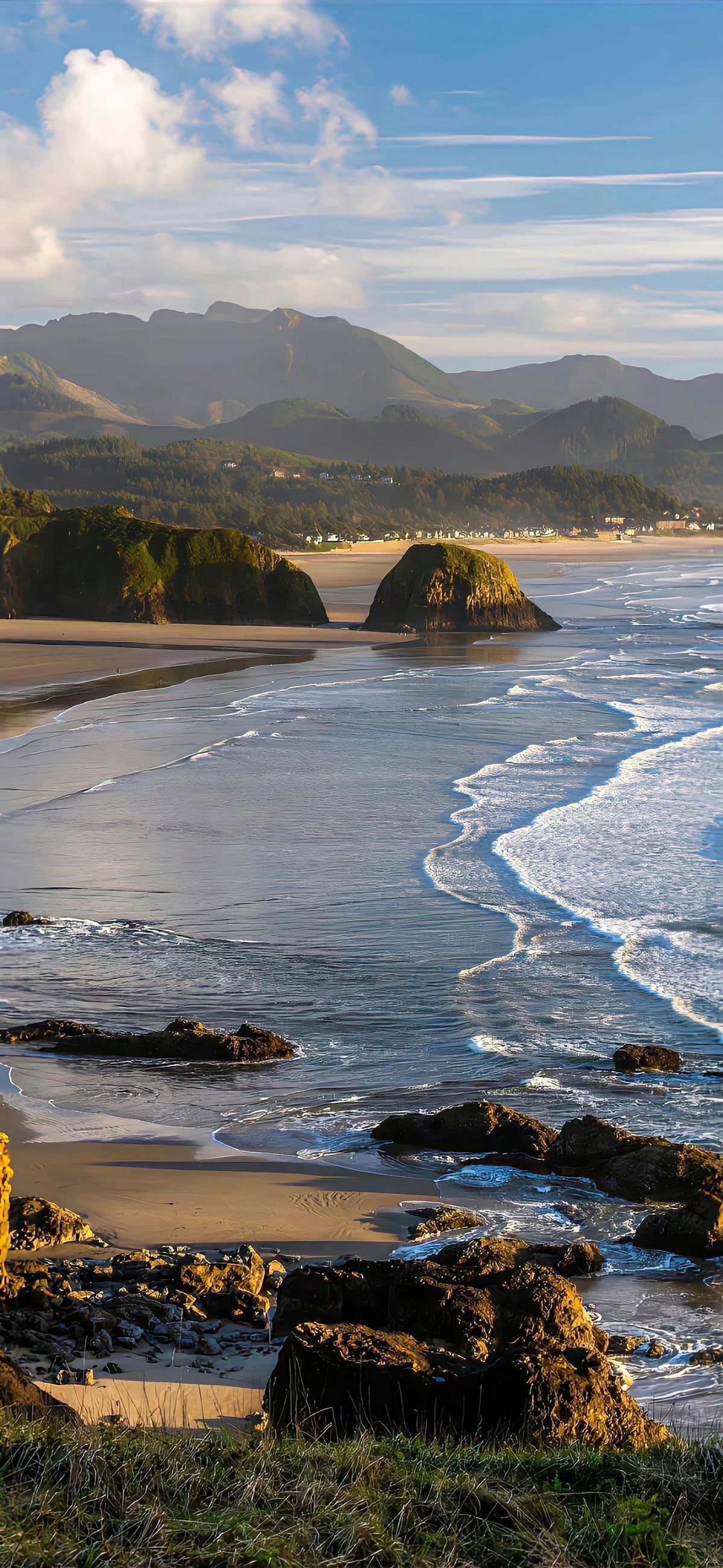 Serene Ocean Waves and Distant Peaks Download Wallpapers